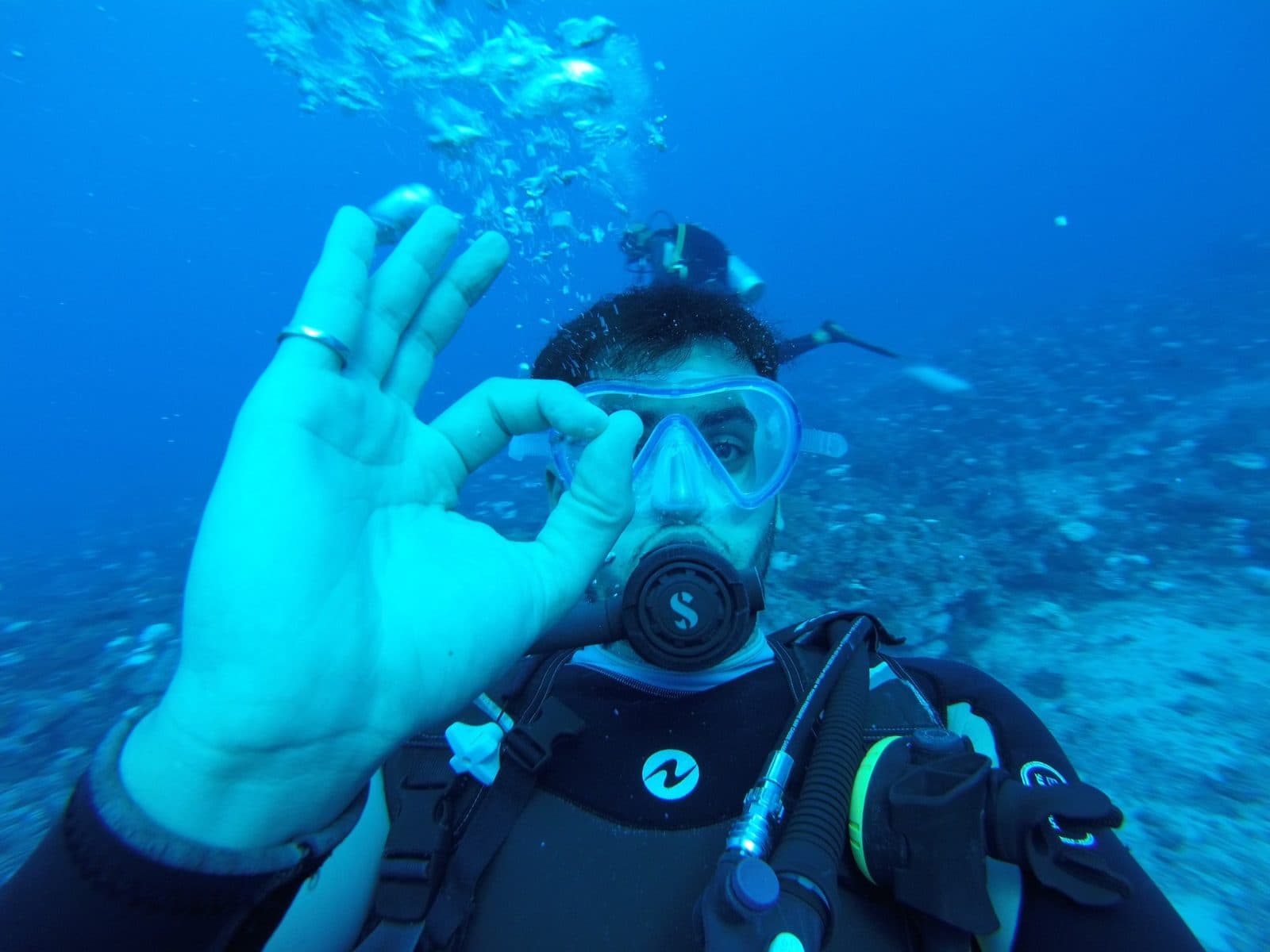 Patrick scuba diving, giving the OK sign